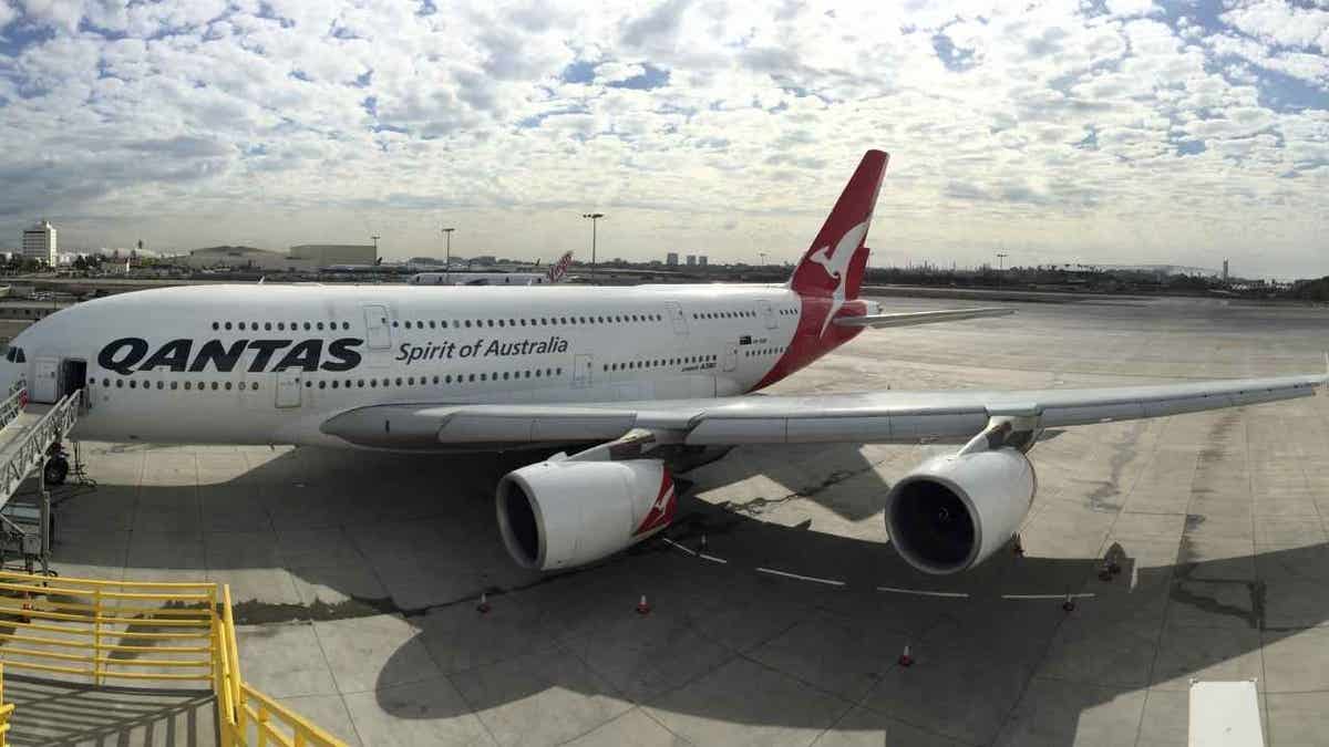 Qantas data breach exposes millions of customer records 5 Qantas aircraft at a gate at the airport.