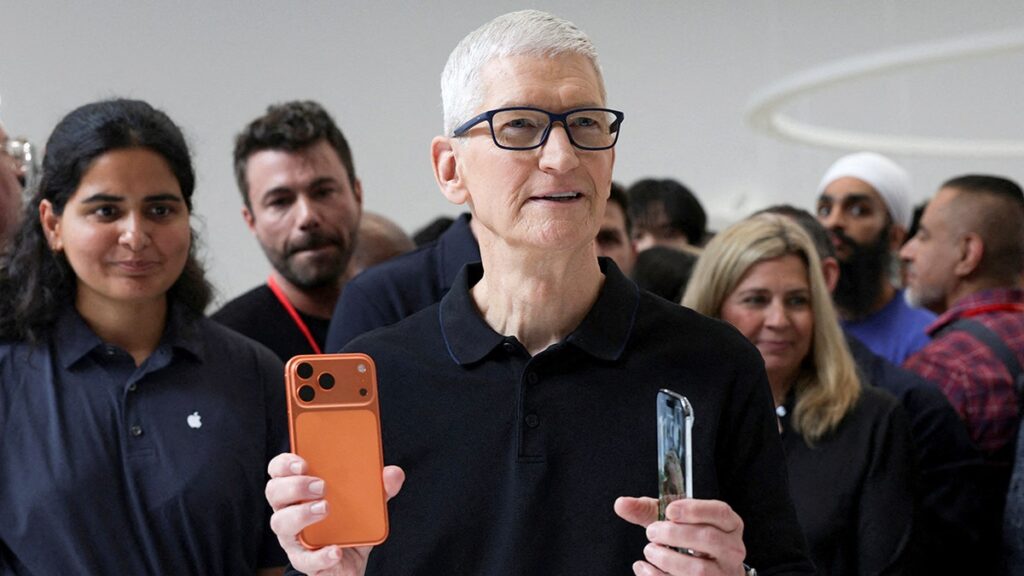 apple ceo tim cook holds iphone 17 pro and air